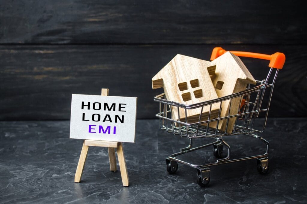 EMI Calculator - Home loan concept with houses in shopping cart