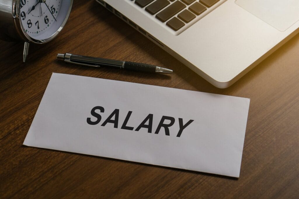 Salary Calculator - Salary money in paper envelope at workplace