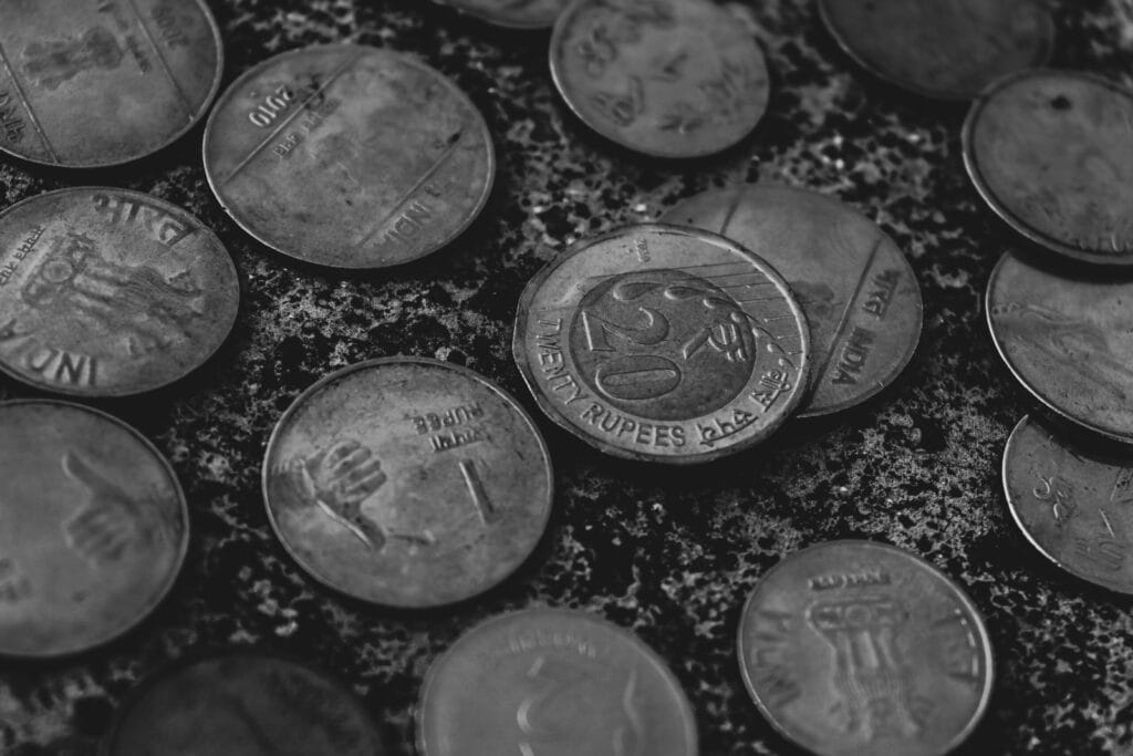 Stack of Indian rupee coins symbolizing PPF, EPF, KVP, NSC, SCSS and FD small savings interest rates
